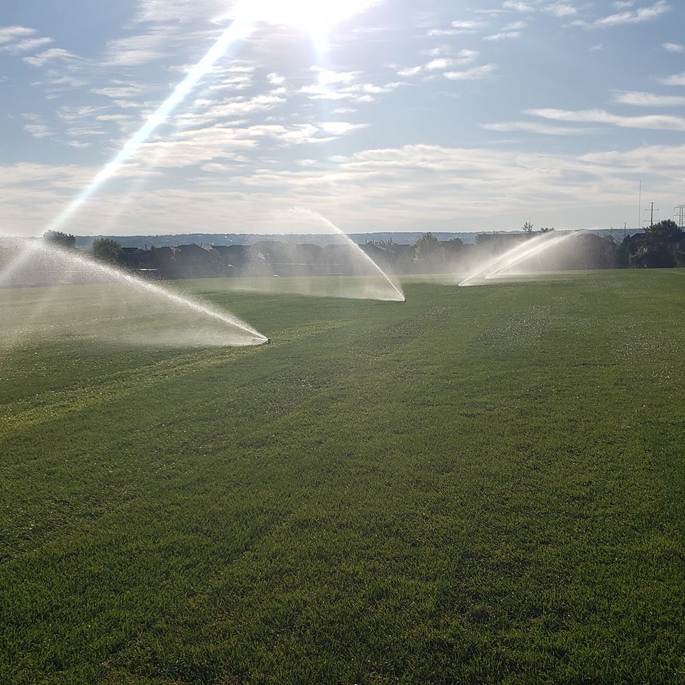 Utah Sprinkler Pros technician ensuring a thorough sprinkler blow out to protect a Utah County property's irrigation system