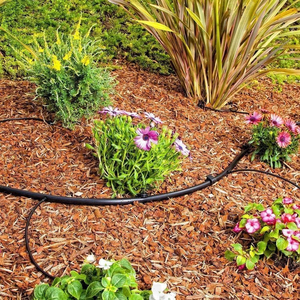 drip line irrigation utah, Technician performing irrigation repair on a damaged sprinkler head near a residential flower bed